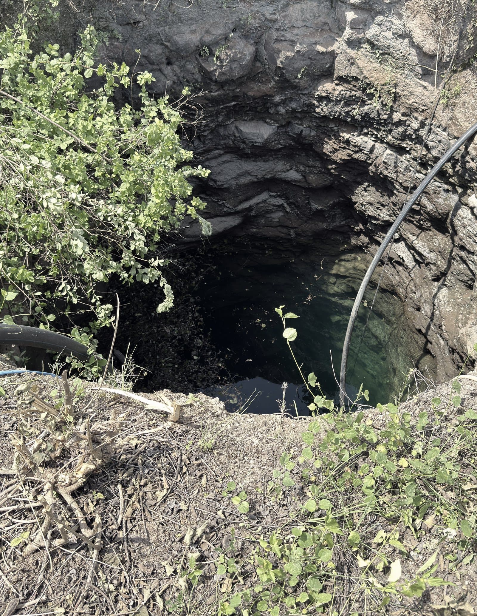 The farm well, cut into dark Deccan rock