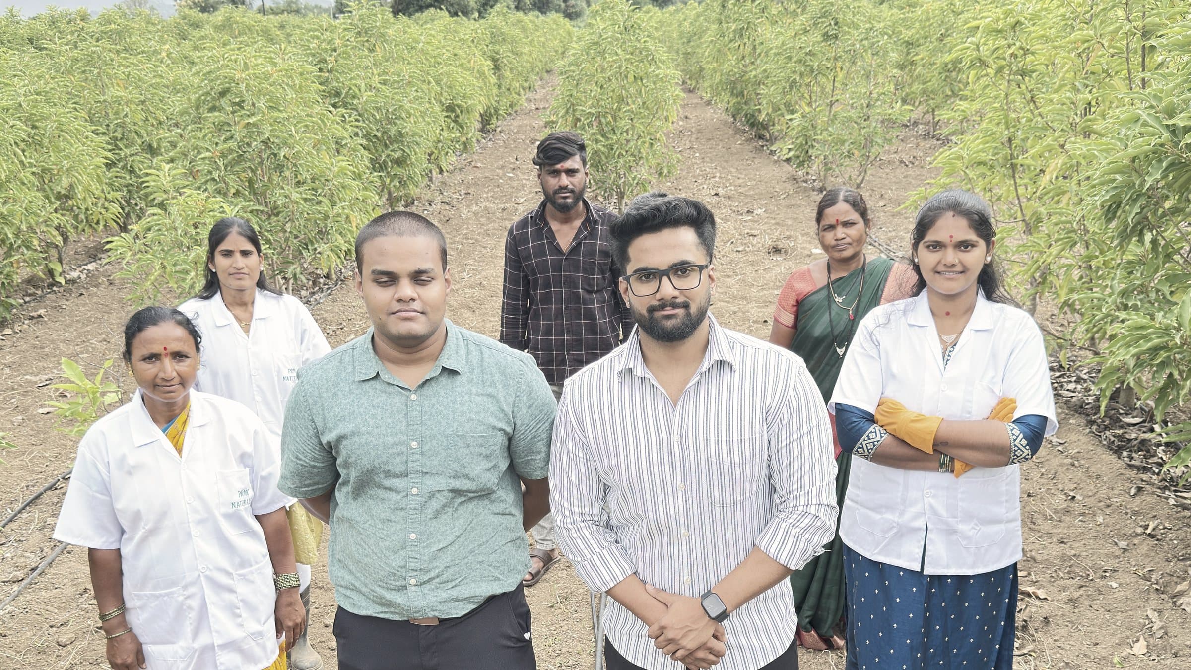 The L’Or Champaca team among the champaca rows